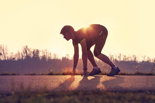 Athletic man starting evening jogging