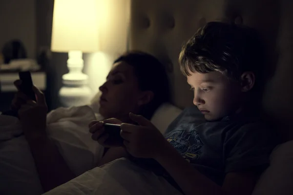Mother with son using devices