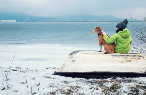 Boy with dog on old boat