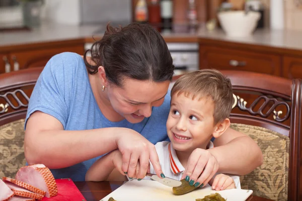 Mother and son making pizza together