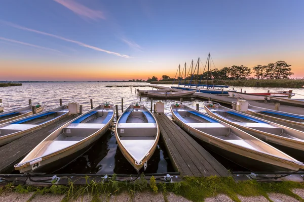 Rental boats in a marina at sunrise