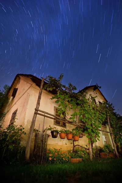 Old house with star trails