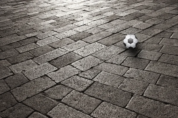 Sunset on cobblestone with soccer ball