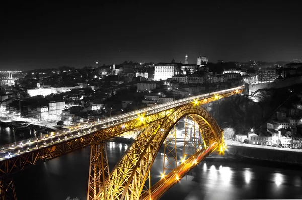 Golden Bridge on a monochromatic background, night view of the Dom Luiz bridge, Porto , Portugal