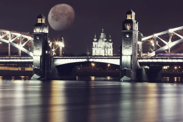 Night landscape with old bridge and moon in background . Fantasy vintage landscape. St. Petersburg