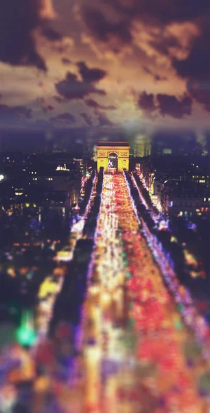 Champs Elysees at night . Blured tilt shift vintage style picture.