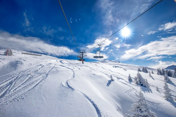 Skiers on ski lift enjoying view