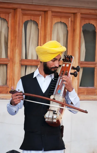 Indian musician playing sarangi in Golden Temple in Amritsar. India