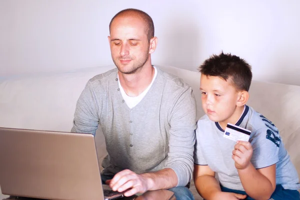 Young faher with child buying online at home