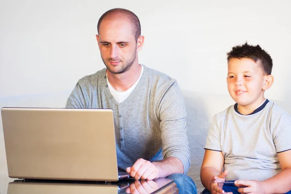 Young faher with child buying online at home