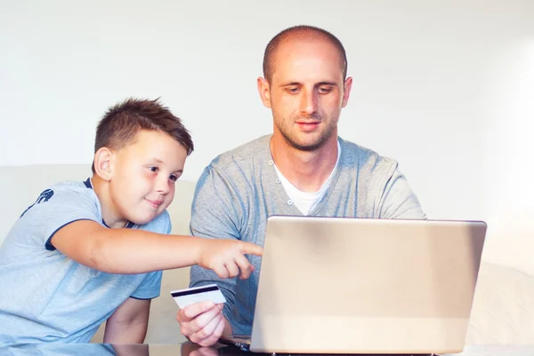 Young faher with child buying online at home