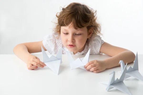 Little girl with paper cranes