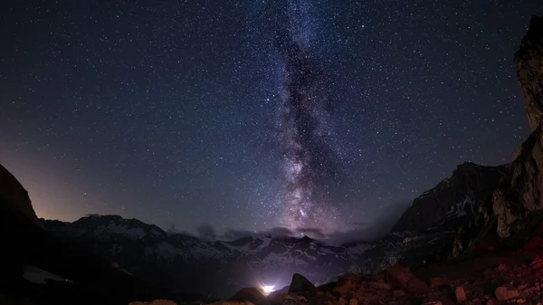 The outstanding beauty of the Milky Way arc and the starry sky captured at high altitude in summertime on the Italian Alps, Torino Province. Fisheye scenic distortion and 180 degree view.