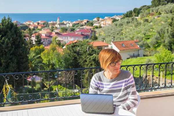 Woman working with netbook outdoors