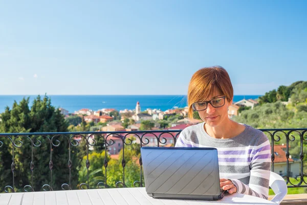 Woman working with netbook outdoors