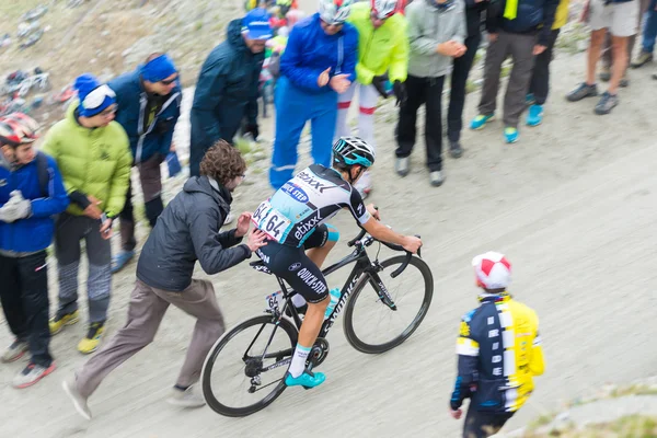 Tour of Italy: supporter pushing cyclist on mountain road