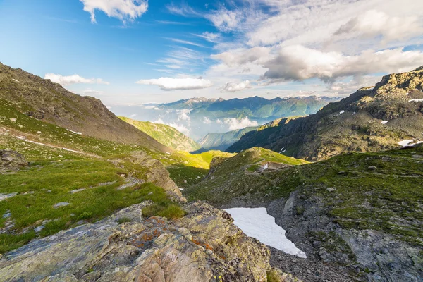 Glowing alpine valley at sunset from above