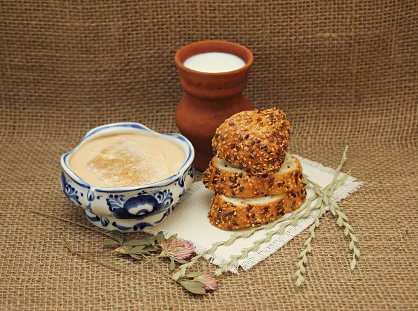 Milk fermented baked milk in pottery and bread with sesame seeds