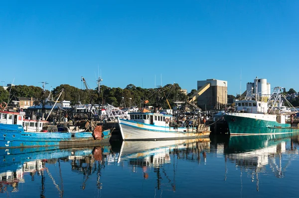 Fishing boats, trailers at port