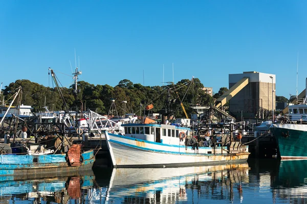 Fishing boats, trailers at port