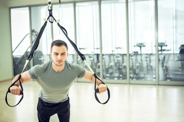 Suspension straps training in modern fitness facility
