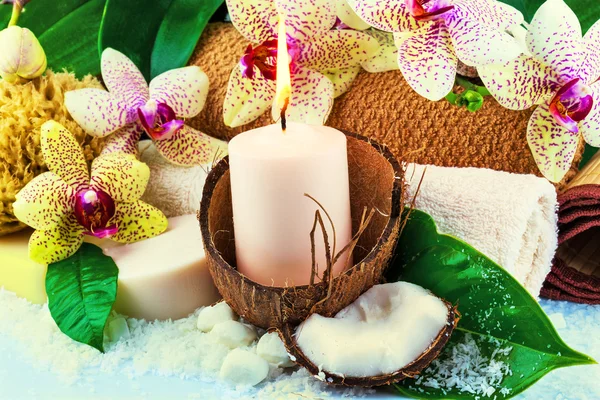 Spa concept with candle, coconut, orchid
