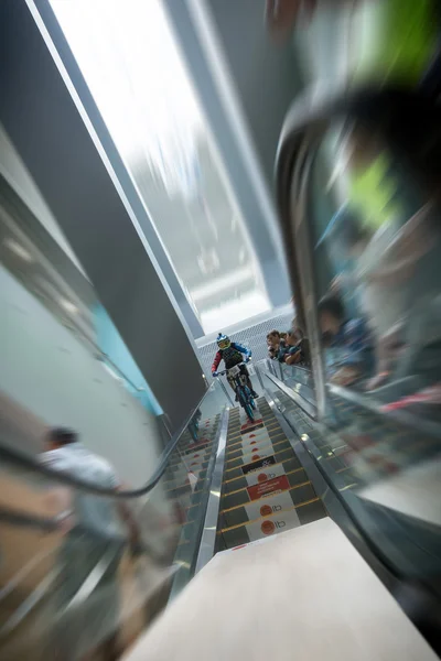 Moscow, Russia, September 13. Biker on mountain bike riding down the stairs past blurred viewers at DownMall contest in Moscow, September 13, 2014 in Moscow, Russia