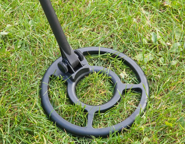 Metal detector coil standing on grass