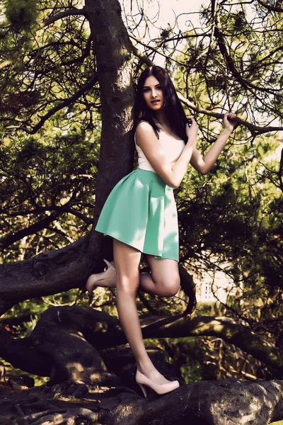 Young beutiful tall woman with long straight dark hair posing in