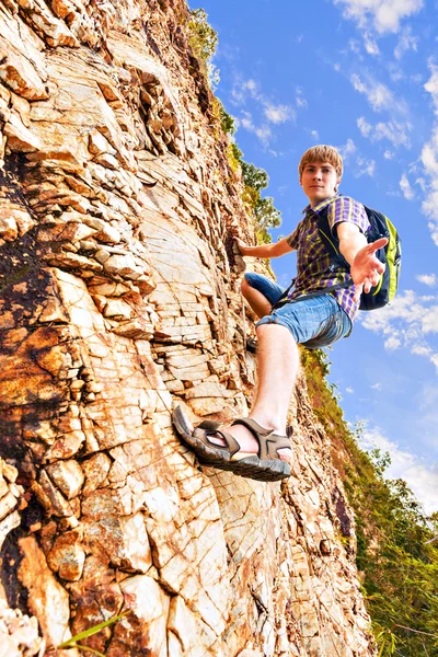 Man climbing up red rock