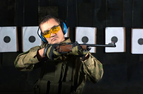 Man shooting with rifle