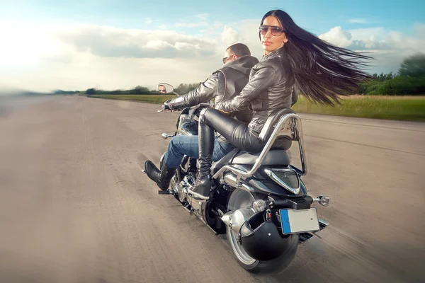 Man and woman riding on motorcycle