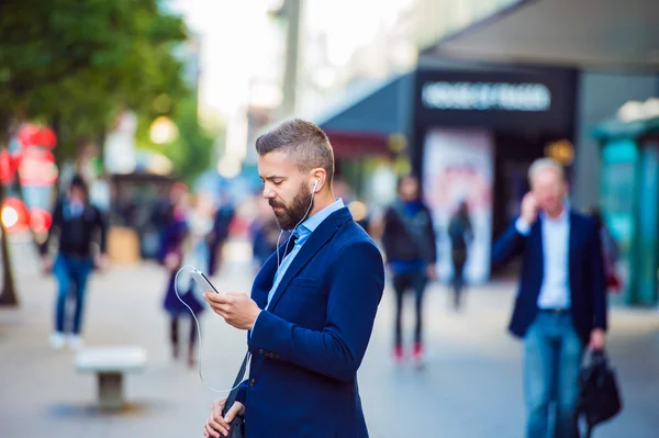 Manager with smartphone listening music