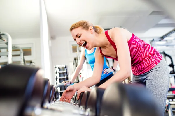 Women in gym laughing