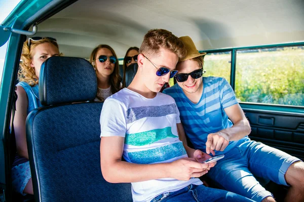 Teenagers with smartphone on trip