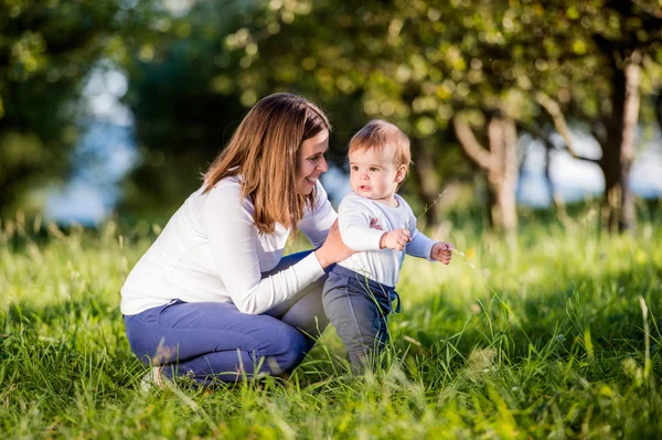 Mother with son making first steps