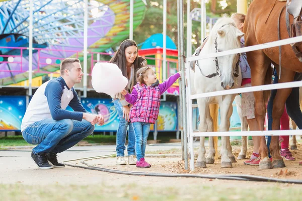 Family with daughter in amusement park