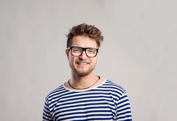 Man in striped t-shirt and eyeglasses