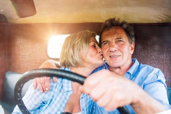 Senior couple inside pickup truck