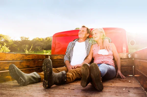 Senior couple in pickup truck