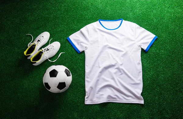 Soccer ball, cleats and white t-shirt