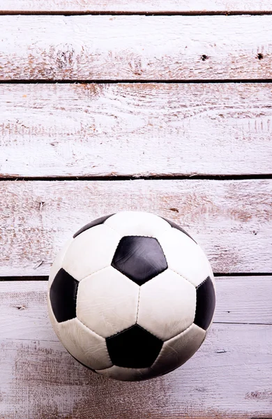 Soccer ball against wooden background. Studio shot. Copy space.
