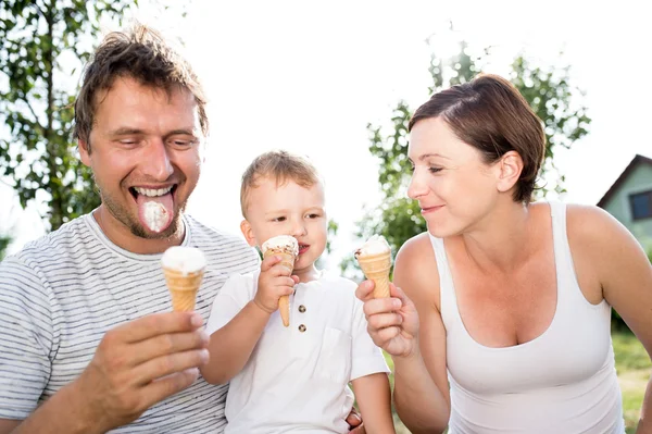 Father, mother and son eating ice cream, sunny summer
