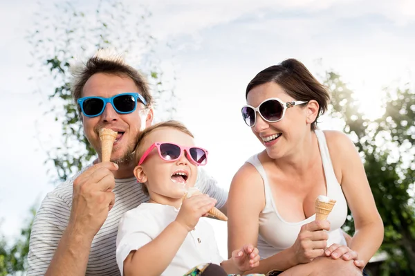 Father, mother and son eating ice cream, sunny summer