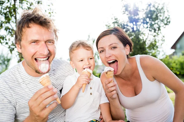 Father, mother and son eating ice cream, sunny summer