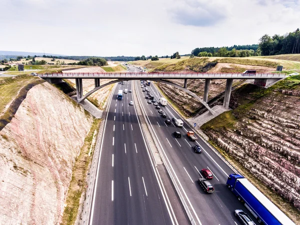 Aerial view of highway, traffic jam, green forest, Netherlands