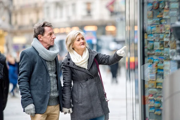 Senior couple shopping in center of city.