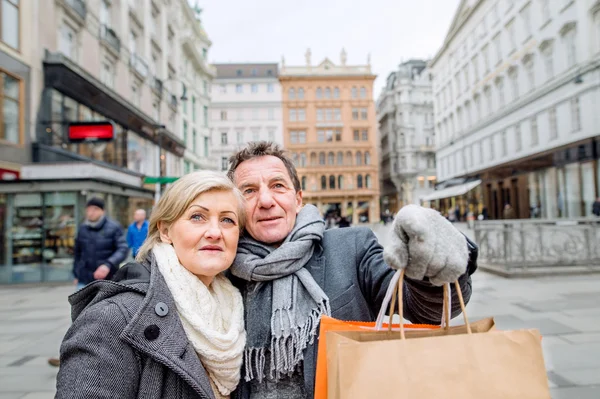 Senior couple shopping in center of city.