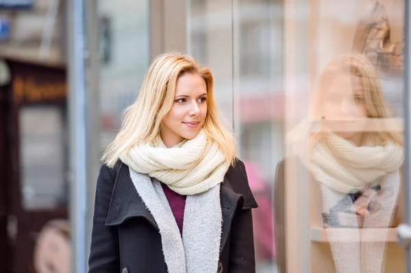 Woman window shopping in centre of the city. Winter