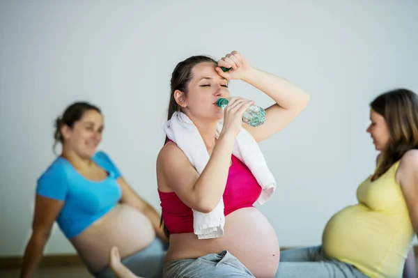 Pregnant women having refreshment break